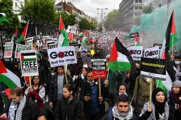Pro-Palestine protest, London. Professionally developed signs, logos, and slogans in wide circulation. Source: NBC News.